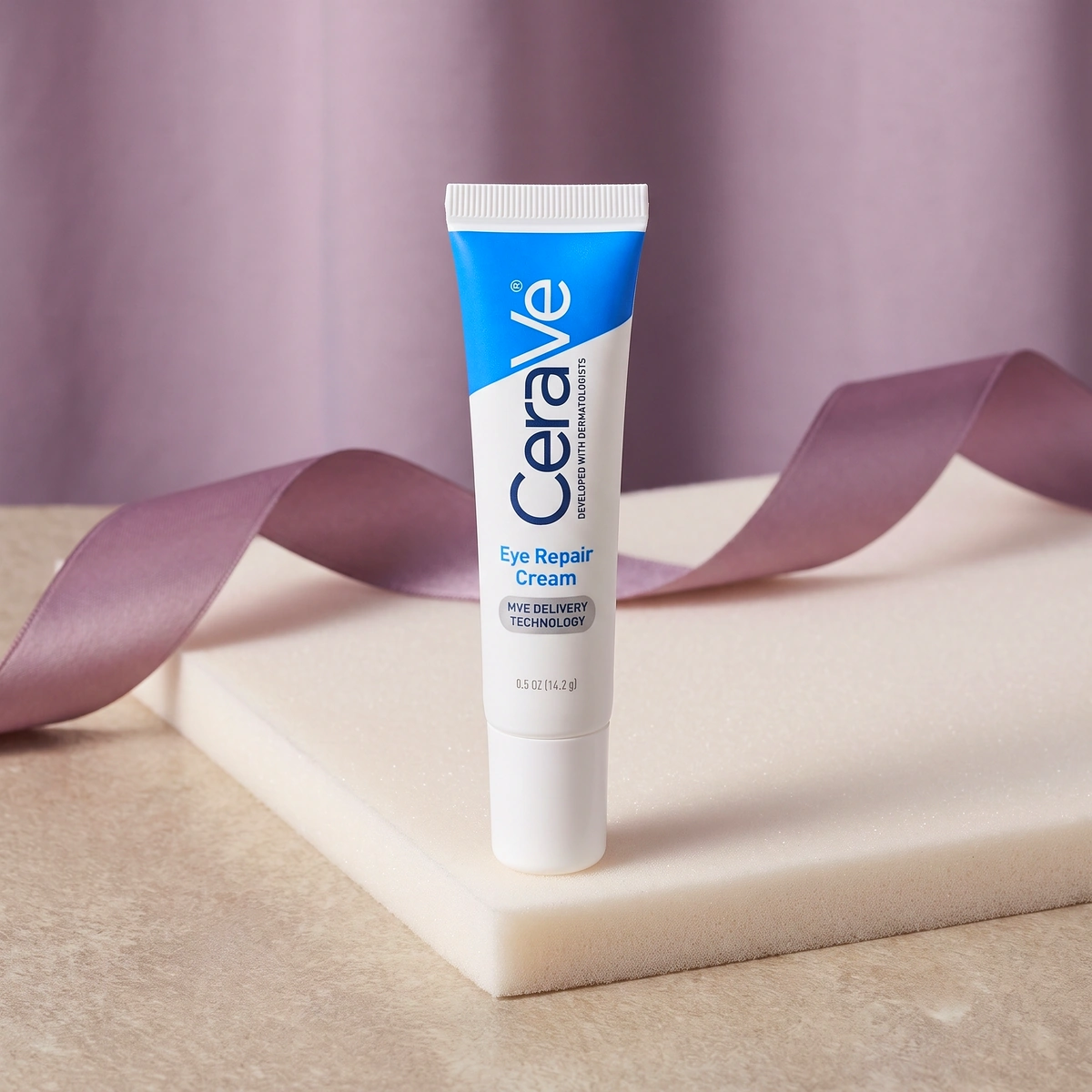 CeraVe Eye Repair Cream tube on warm stone, with a pale body and a blue accent