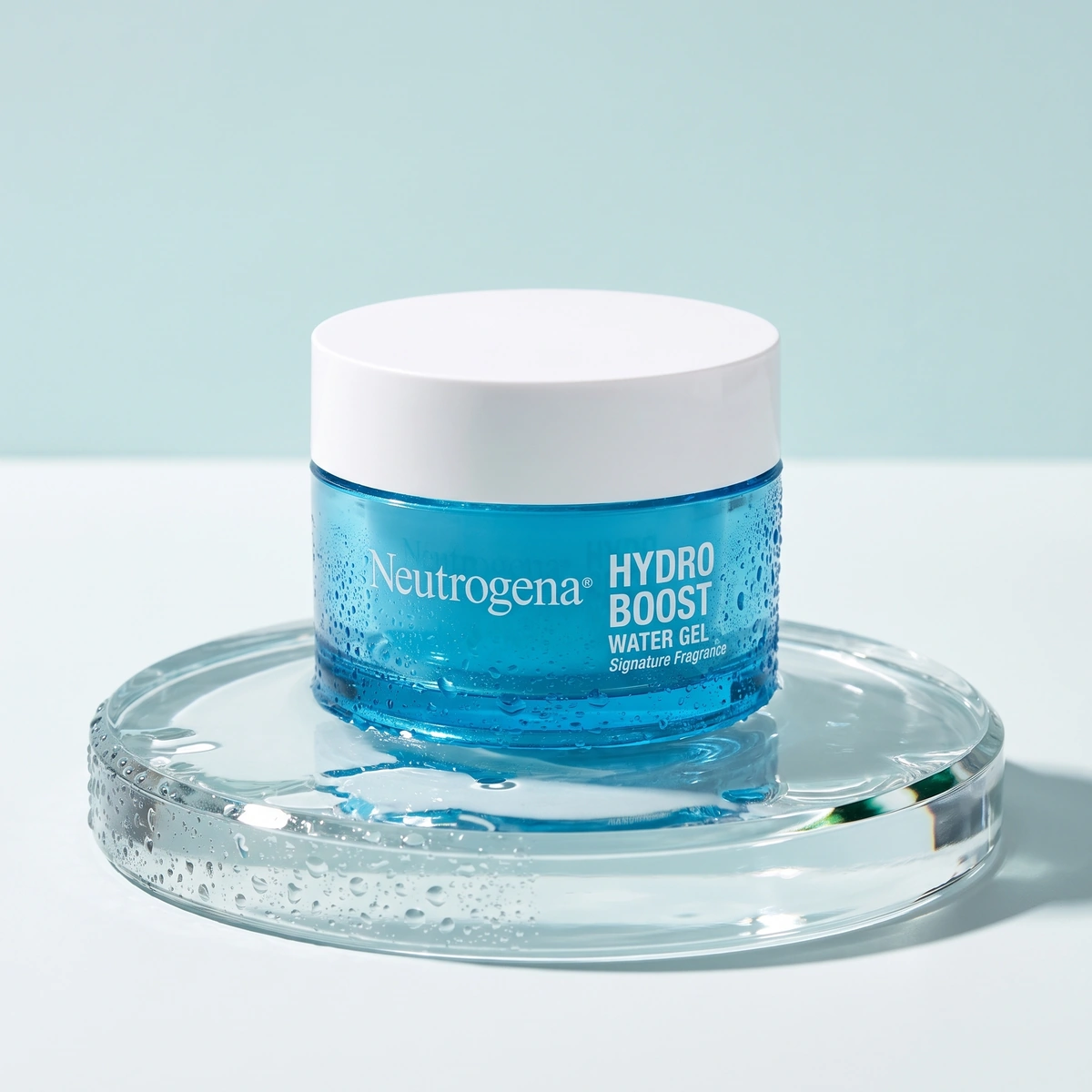 Neutrogena Hydro Boost Water Gel jar on a wet glass disc, with a white lid and clear droplets